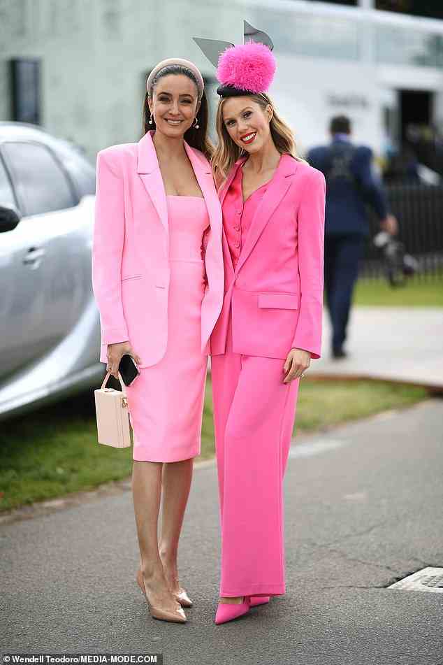 Seven presenter Abbey Gelmi (left, with a friend) channelled her inner Barbie by wearing a pink midi dress and matching blazer