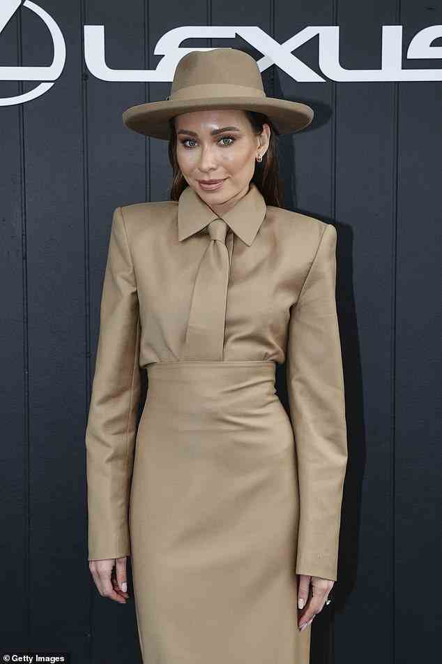 Rozalia, 34, dressed modestly in a tan brown maxi dress and matching brimmed hat