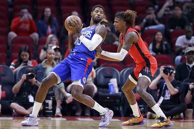 Los Angeles Clippers guard Paul George (13) leans into Houston Rockets guard Jalen Green