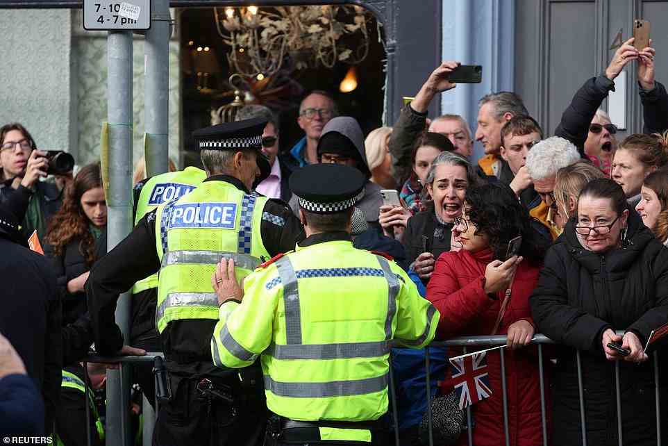 Police move into the crowd to grab the man after he was spotted throwing eggs today on Micklegate Bar in York