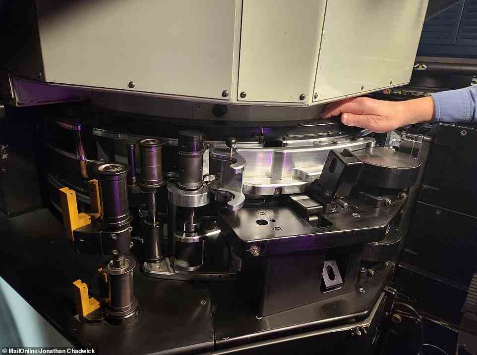 A projectionist operates the IMAX 70mm film projector. The 70mm film reels are so heavy they need to be moved around the room with a small forklift