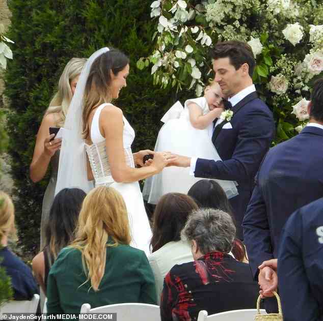 Matty held his daughter Lola in his arms as Laura slipped a wedding band on his finger