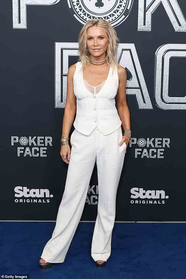 Russell Crowe's ex-wife Danielle Spencer was all white on the night in a pale vest with a lace peekaboo portion and matching trousersts of accessories including multiple choker necklaces and metallic bangles.