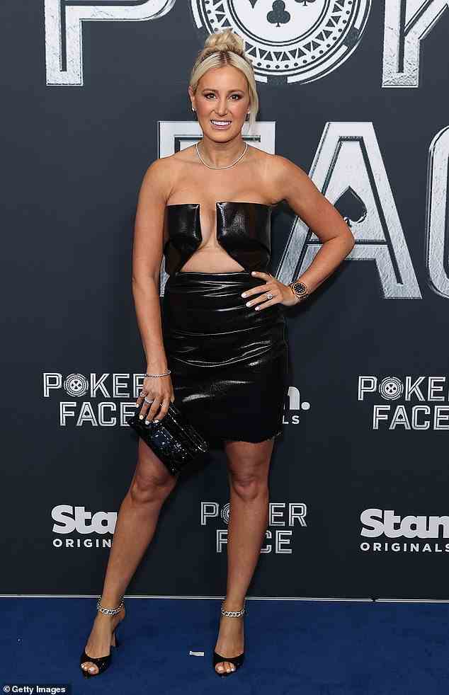 The PR Maven matched the frock, which including cutouts that showed off some skin, with a pair of towering heels with chain detailing and designer clutch purse