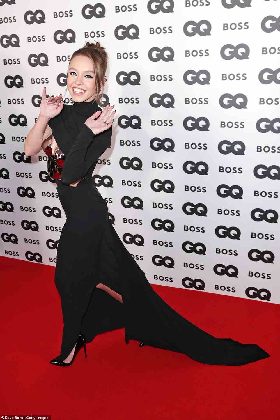 Waving: Sydney looked exceptional in her gorgeous black gown which featured a stunning black train and a gold corset