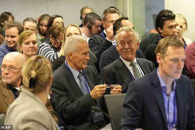 Piet Ploeg, who lost his brother, his sister-in-law and his nephew in the downing of MH17, spokes person for the relatives of the victims smiles (centre right wearing green tie) before the verdict session of the Malaysia Airlines Flight 17 trial at the high security court at Schiphol airport, near Amsterdam, Netherlands on Thursday