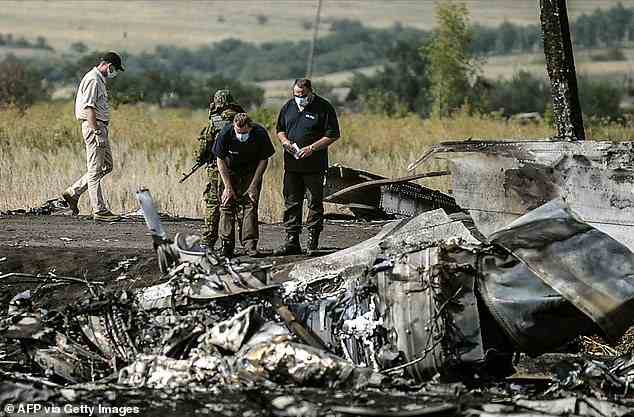 Investigators work at a the crash site of the Malaysia Airlines Flight MH17 near the village of Hrabove (Grabovo), some 80km east of Donetsk, on July 25, 2014