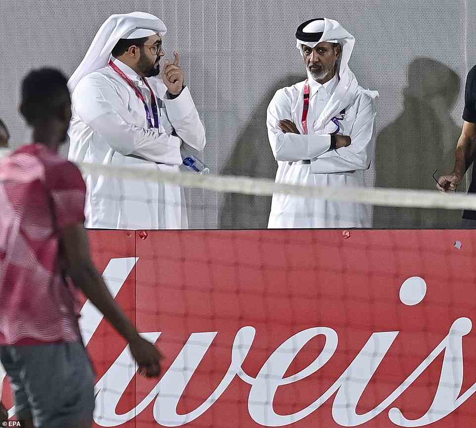 Sheikh Hamad bin Khalifa bin Ahmed Al Thani (right, facing camera), president of the Qatar Football Association, stands by a Budweiser hoarding at a training session ahead of the World Cup