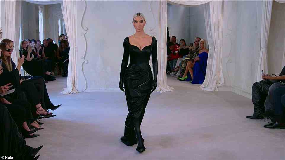 Kim walks: Kim is getting ready to walk the runway, following a number of models with black plastic shields over their faces, as Kim walks shield-less