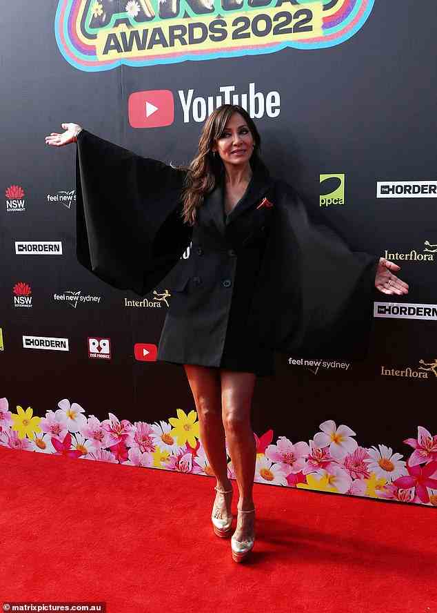 The star playfully put her hands out to show off the statement sleeves on the red carpet