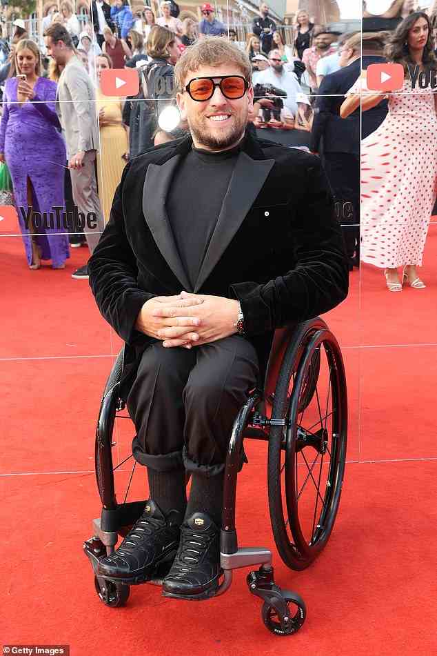 Australian of the Year Dylan Alcott looked typically stylish in a black suit which he gave a contemporary twist to with a black polo neck and Nike Air Max sneakers