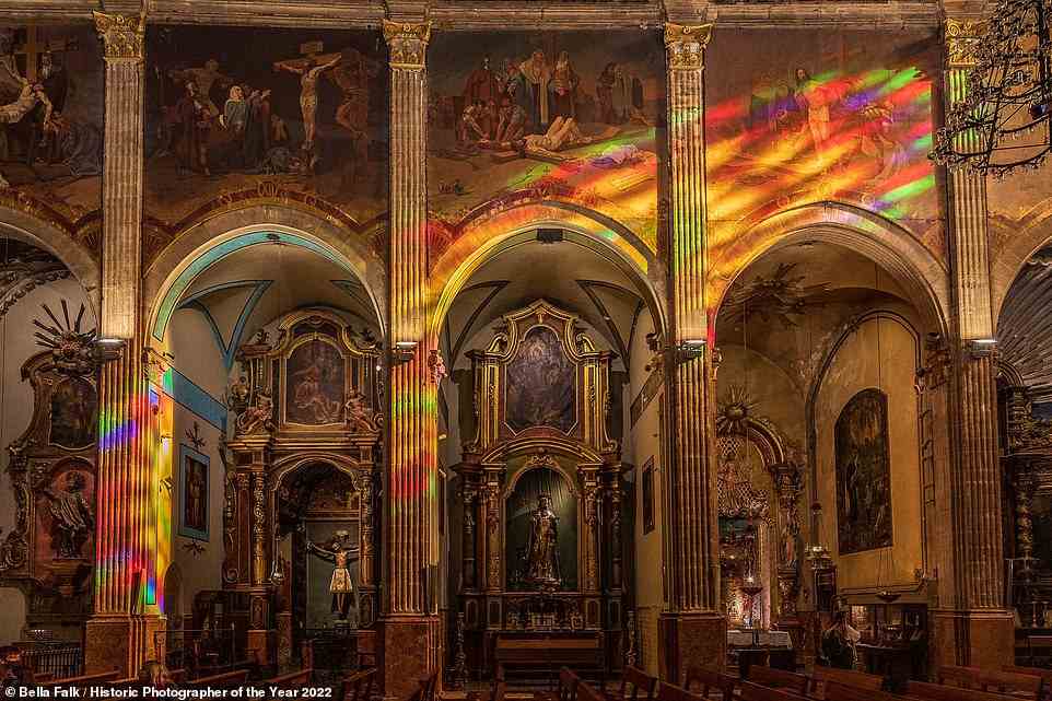 In this evocative shot, light filters through the stained glass windows of the 13th-century Church of Our Lady of the Angels in the Mallorcan town of Pollenca, casting 'a rainbow of colours on the wall'. The picture has been shortlisted in the World History category