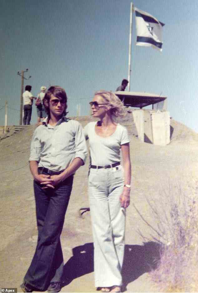 Rory Knight Bruce stands on the beach with his mother Gwynneth Tyghe (later Princess Elizabeth Galitzine) on holiday in Israel in 1975