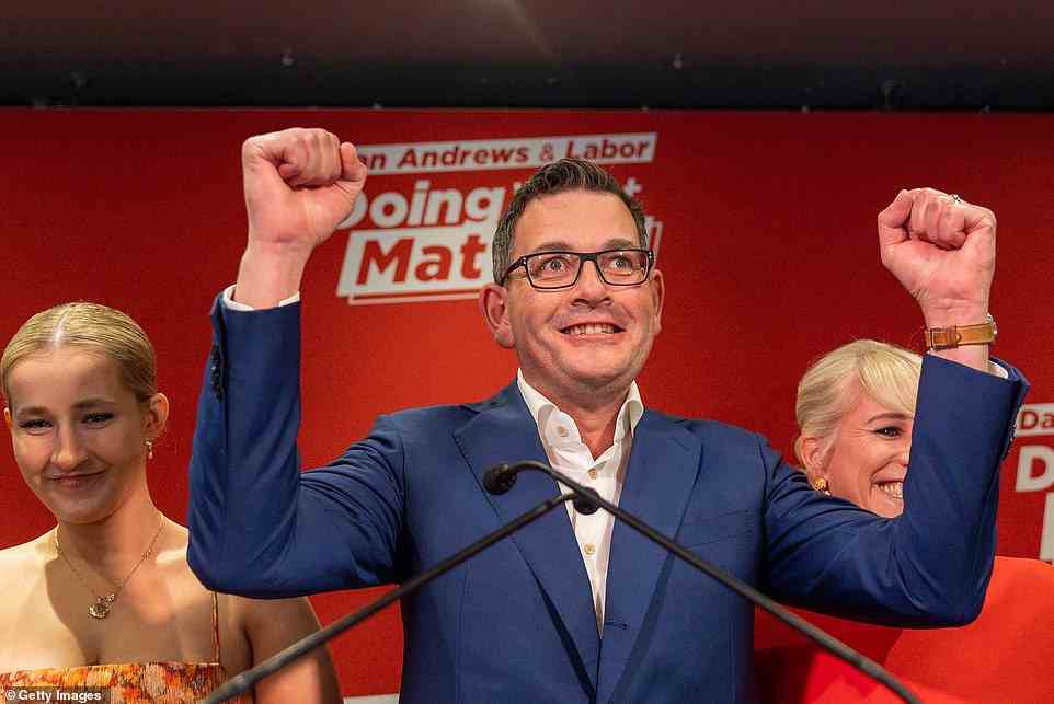 Victorian Premier Daniel Andrews celebrates during his victory speech at the Labor election party surrounded by his wife and children