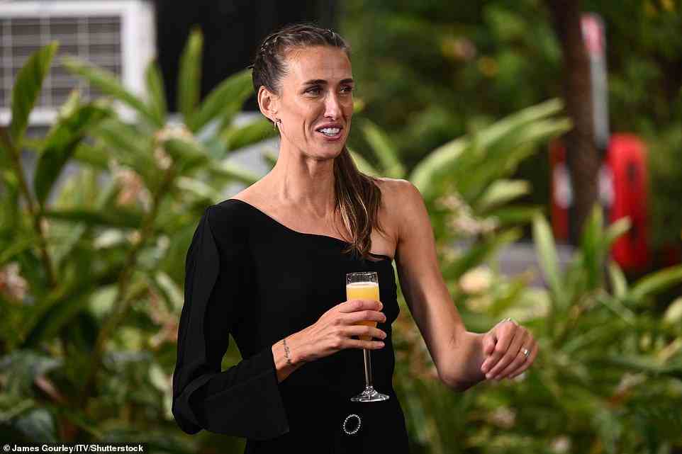 Striking: The former footballer swept her brunette locks back into a neat high ponytail, and completed the look with a pair of small gold hopped earrings and a selection of dainty charm bracelets