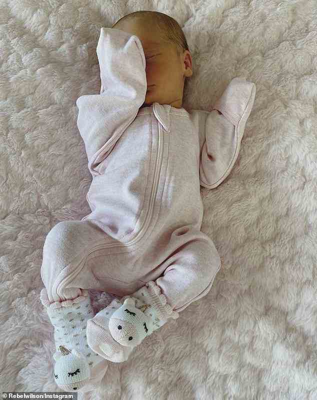 The blonde beauty posted a photo of the child in a light pink onesie with unicorn socks along with a sweet caption sharing how proud she is to become a first time mother