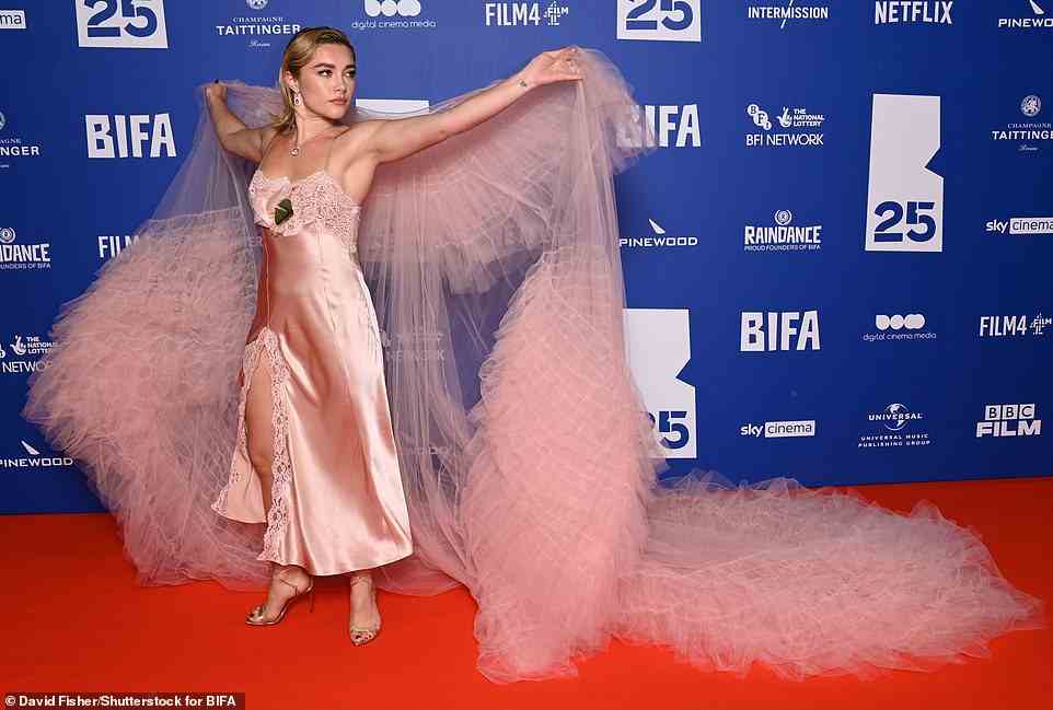 Fashion forward: Her gown featured ruffled detail at the front and a thigh-high split, with Florence putting on a leggy display as she posed at one point