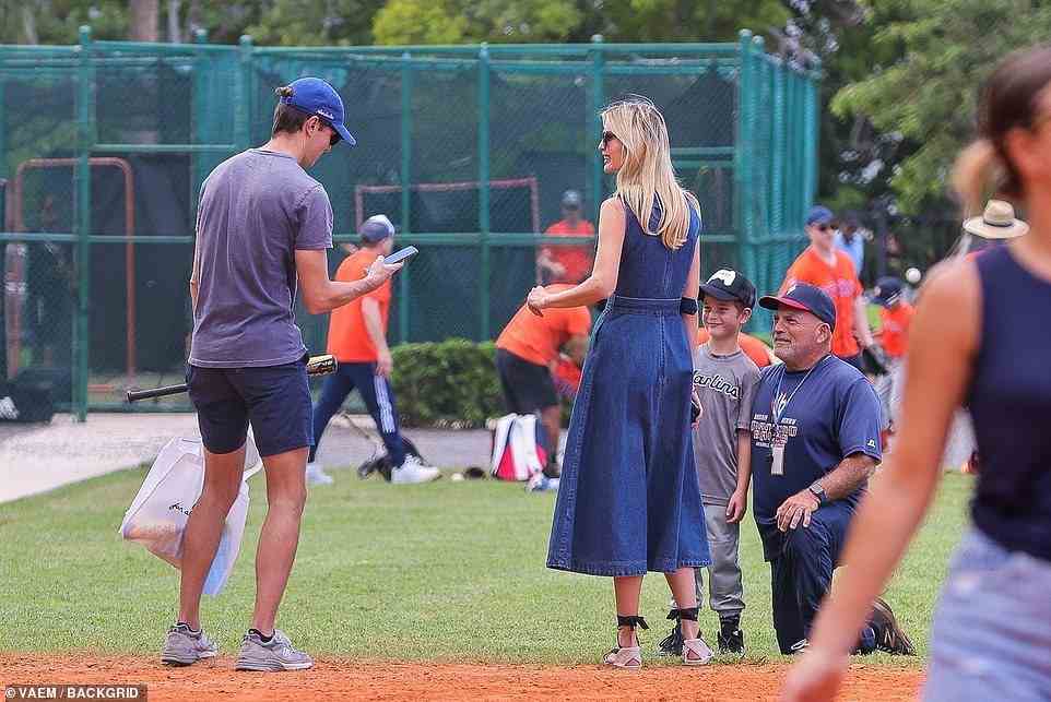 Ivanka smiled brightly as she watched Jared take a photo of Theo with his tee-ball coach