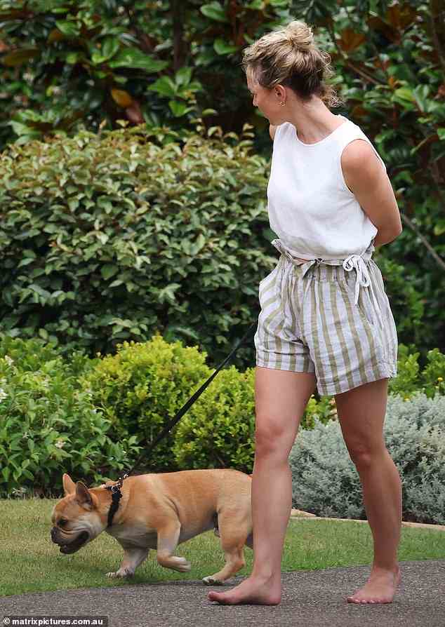 The barefoot blonde wore a sleeveless white T-shirt and showed off her tanned legs in a pair of stripped shorts
