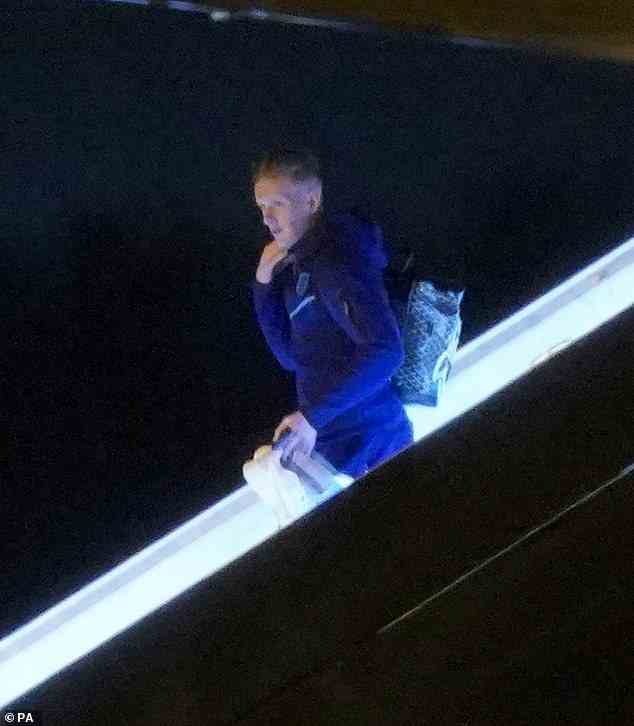 Everton goalkeeper Jordan Pickford walks down the stairs as he exits the plane at Birmingham Airport tonight