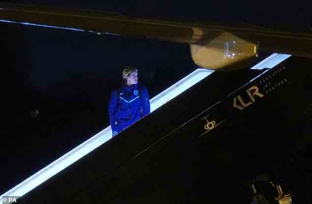 Chelsea midfielder Conor Gallagher looks back up the stairs into the plane after it lands at Birmingham Airport tonight