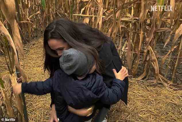Archi, three, is also seen in a sweet video of him running to Meghan's arms in a corn field in the US
