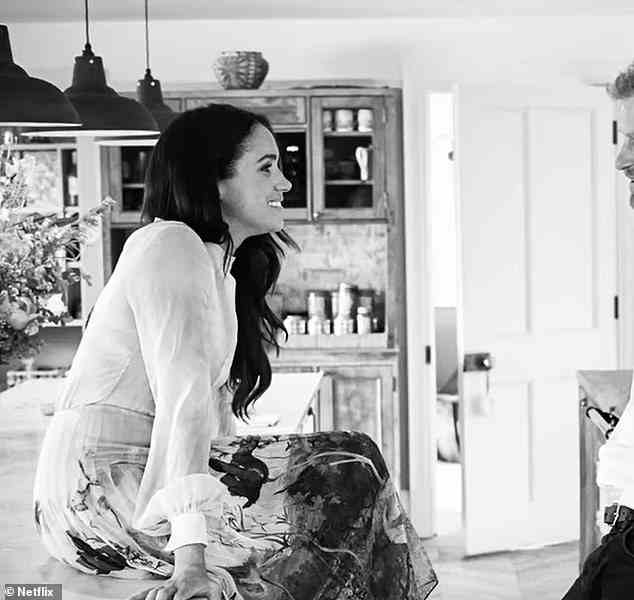 During their visit to the UK, the couple also took a picture in the royal cottage's kitchen, with Meghan casually resting her feet on her husband's thigh as they talked