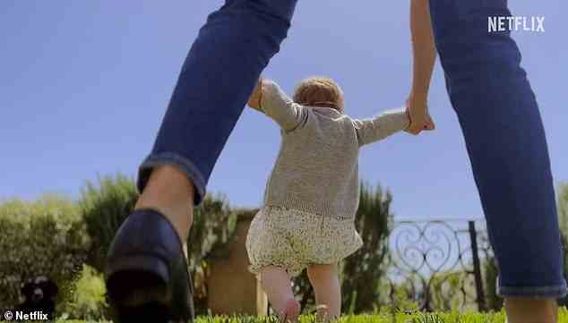 An adorable new clip shows Meghan helping her daughter Lilibet take her first steps around their garden