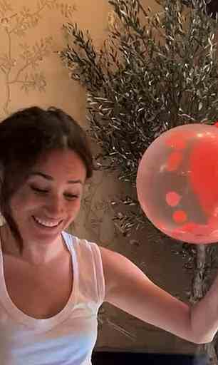 A series of pictures show the couple looking happy and relaxed such as this one of Meghan with a birthday balloon arch