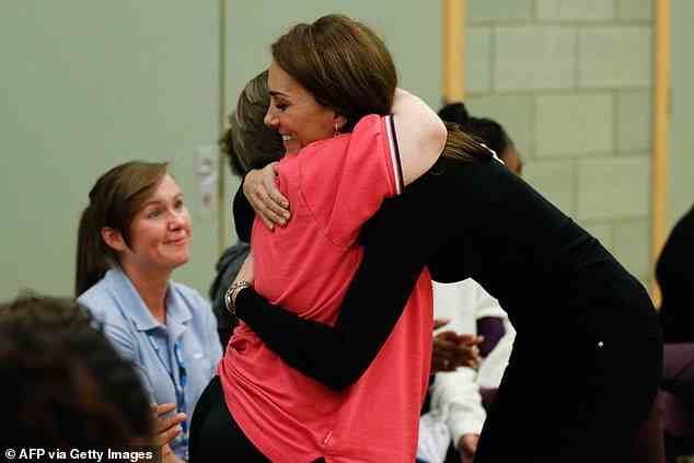 The Duchess of Cambridge hugs a participant as she meets new apprentices and graduates from the Coach Core Essex apprenticeship scheme during a visit at Basildon Sporting Village in October 2018