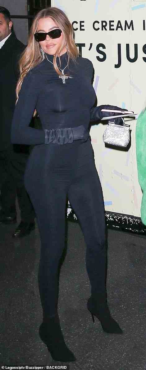 Curvy: Khloe Kardashian got gussied up for the festivities by showing off her sensational curves in a skintight black bodysuit