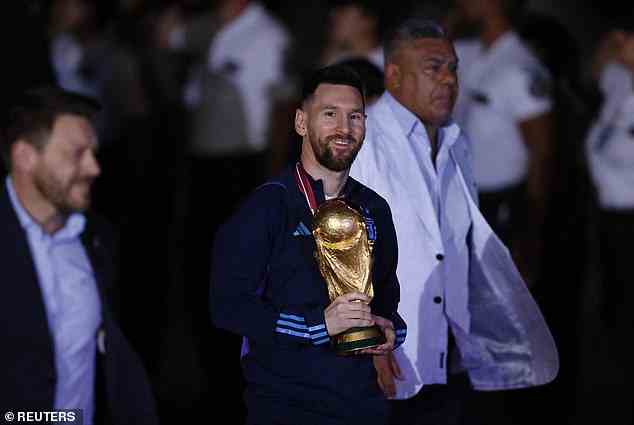 Captain Messi cradled the World Cup trophy as the Argentines returned home after their win
