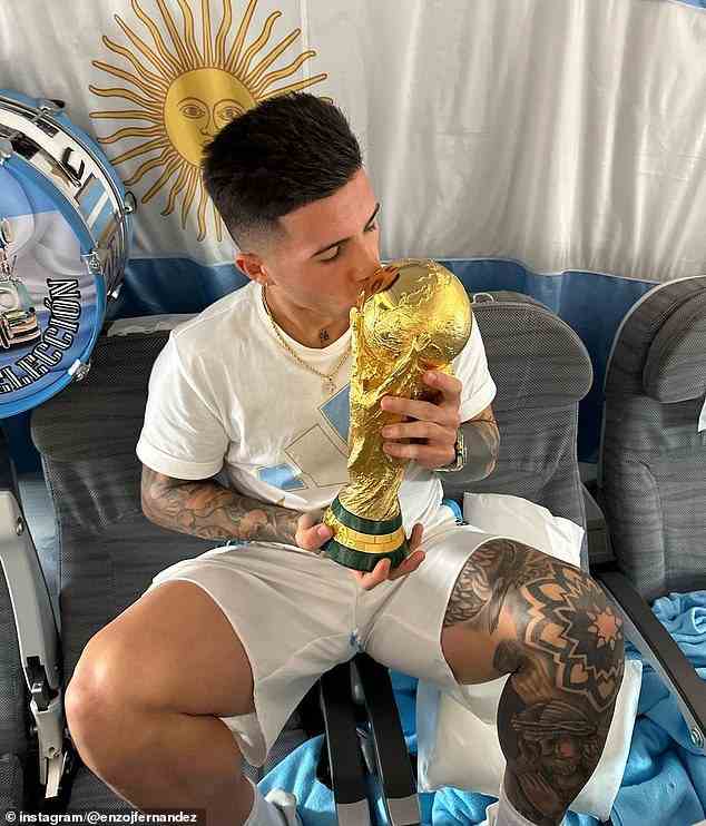 Centre midfielder Enzo Fernandez (above) also kissed the trophy in front of his country's flag
