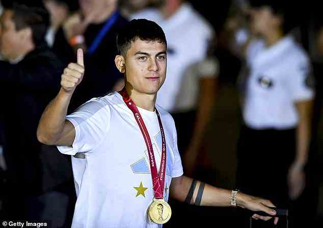 Paulo Dybala proudly has his medal on show as he gives a thumbs up to the onlookers