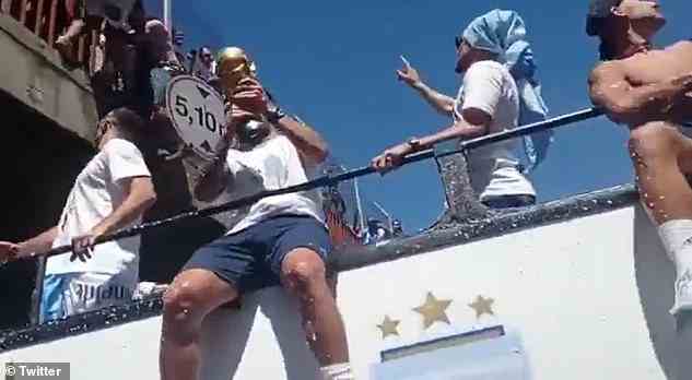 Supporters threw themselves from the bridge as the celebrating players showed the World Cup trophies to the huge crowds in Buenos Aires on Tuesday
