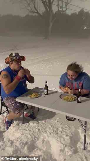 Others took the opportunity to brave the wild weather, this couple seen eating their dinner at the peak of the storm on Dec 23