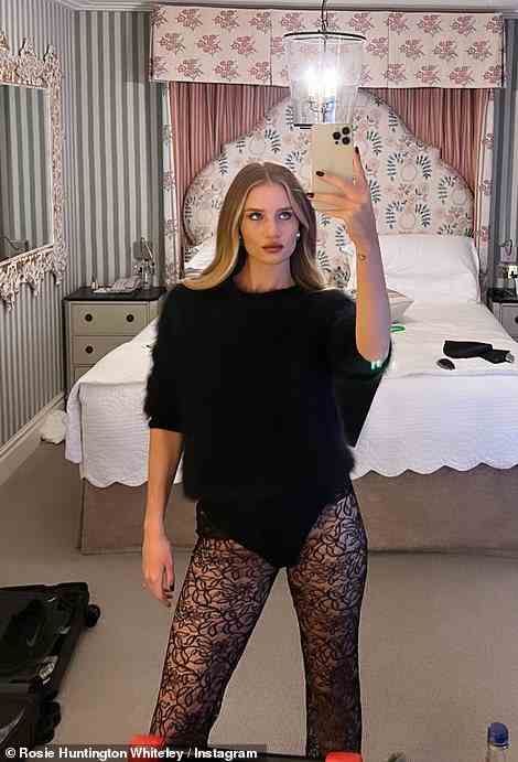 Hot stuff: Rosie Huntington-Whiteley turned up the heat on Christmas Eve on Saturday as she posed up a storm in racy black lace leggings