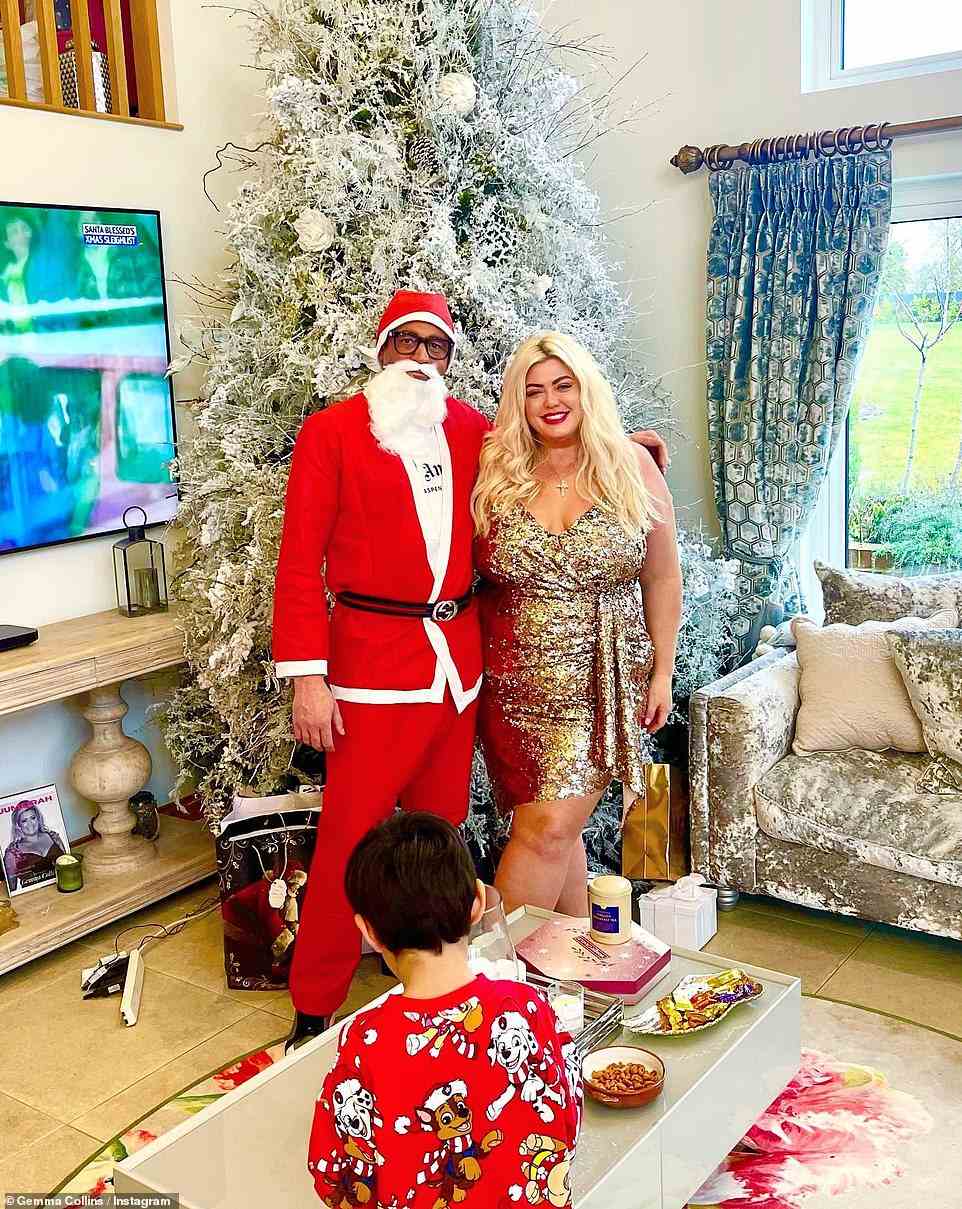 Feeling festive: Gemma Collins - who recently revealed plans to 'cut back' her plans this Christmas, looked sensational in a sparkly gold dress while posing with her fiance Rami Hawash and his son