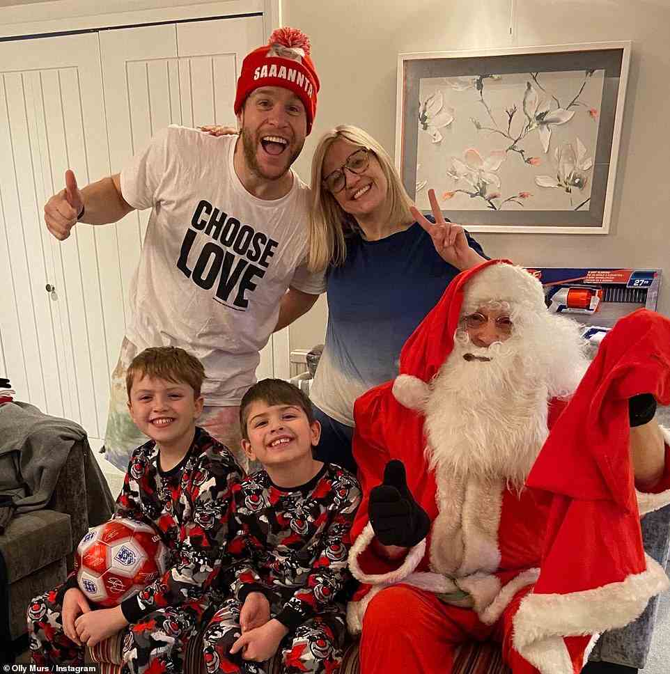 All together now: Elsewhere, Olly Murs had his own Santa join him for a festive snap with his family