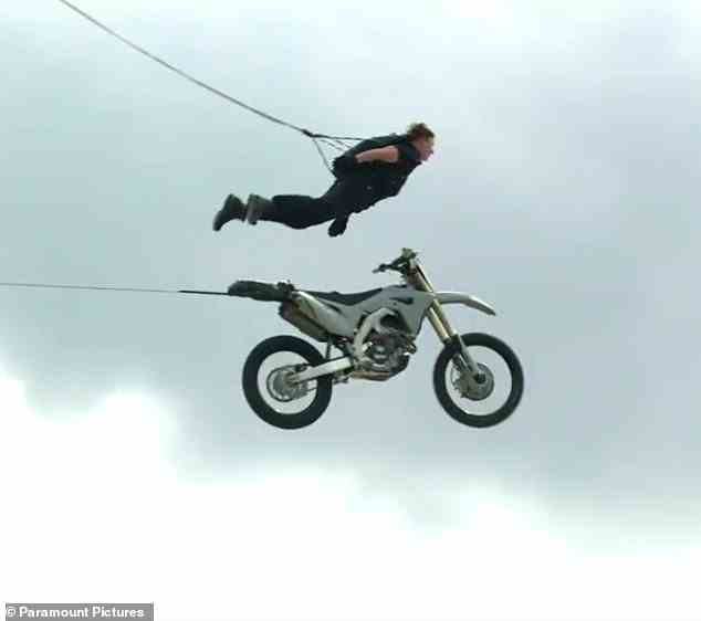 What won't be shown in the final edit is that Cruise had a harness in place as he sails through the air; the motorcycle is attached to a separate cable
