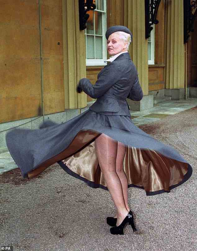 Fashion designer Vivienne Westwood at Buckingham Palace, in London, where she received her OBE from Queen Elizabeth II. She is giving a twirl for the photographers, but beneath her tailored suit she wore no knickers