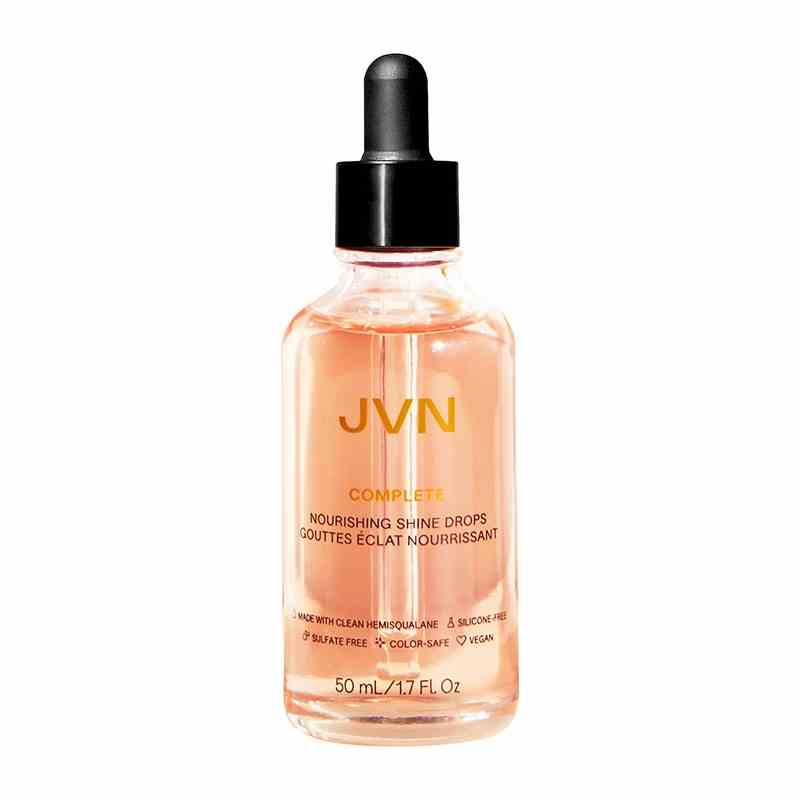 JVN Complete Nourishing Shine Drops Glasflasche mit pfirsichfarbenem Öl auf weißem Hintergrund