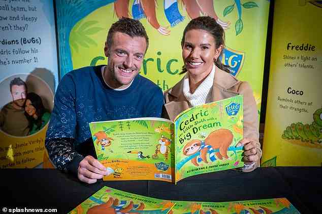 Happy: Rebekah and Jamie Vardy looked in great spirits as they sign copies of their children's novel for queuing fans at the Leicester City Club Store on Thursday