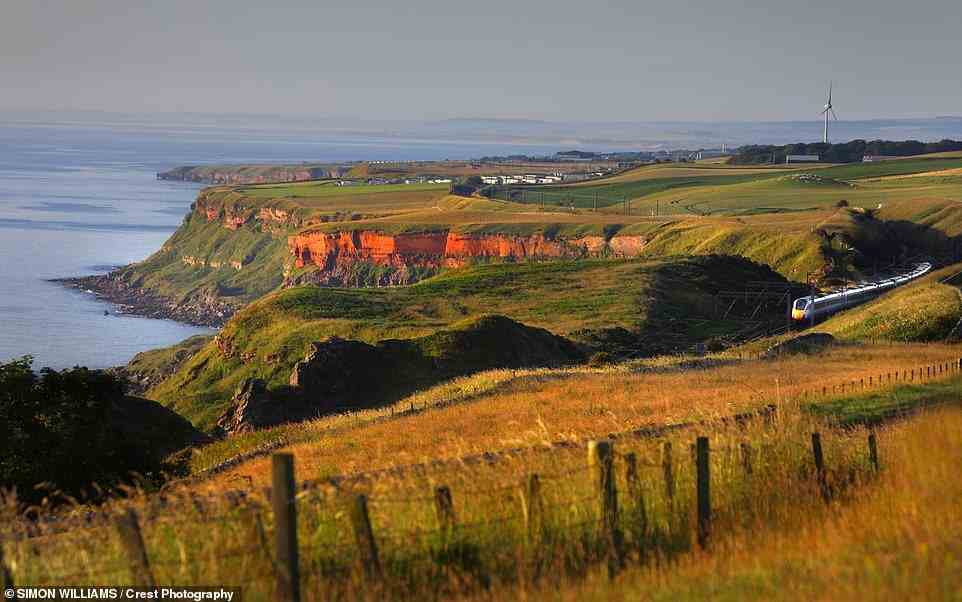 Above: Between Scotland’s Burnmouth and England’s Alnmouth passengers can enjoy 'dramatic peeks down into coves and over cliff-hugging farmsteads'