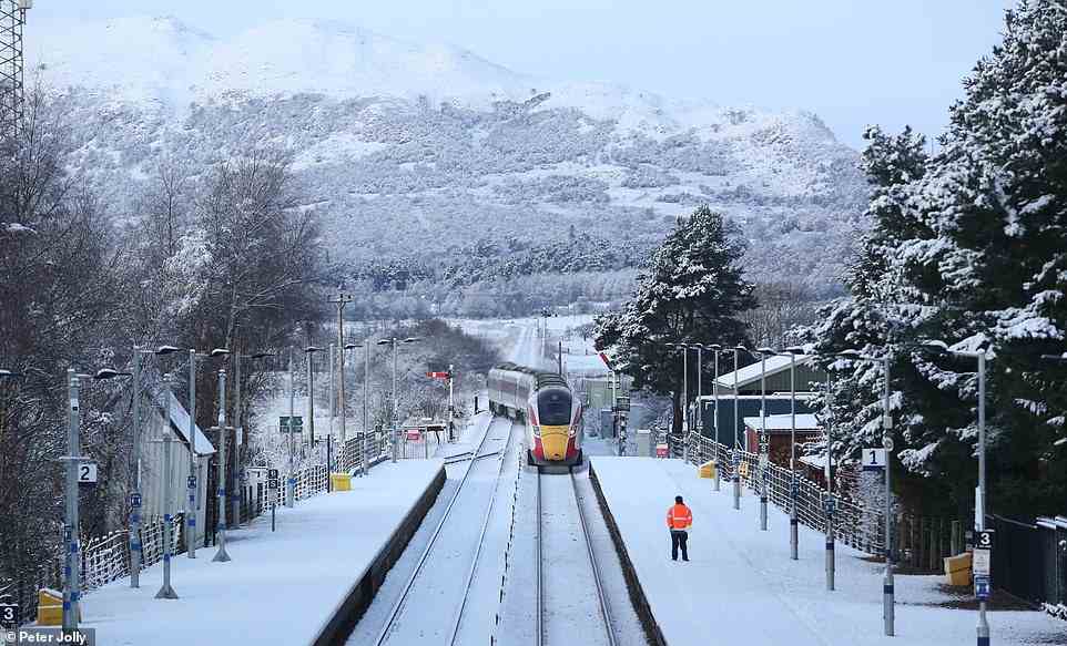 An LNER Inverness to London service approaching Kingussie station in the snow