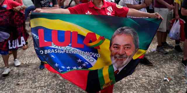 Ein Unterstützer von Luiz Inacio Lula da Silva zeigt während seiner Amtseinführung als neuer Präsident vor dem Präsidentenpalast von Planalto in Brasilia, Brasilien, am Sonntag, 1. Januar 2023, ein Banner. 