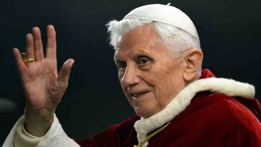 (DATEIEN) Dieses Aktenfoto, das am 29. Dezember 2012 auf dem Petersplatz im Vatikan aufgenommen wurde, zeigt Papst Benedikt XVI., der salutiert, als er die ökumenische christliche Gemeinschaft von Taizé während ihres europäischen Treffens erreicht.  Papst Benedikt XVI. kündigte am 11. Februar 2013 an, dass er am 28. Februar zurücktreten werde, sagte ein Sprecher des Vatikans gegenüber AFP, was ihn zum ersten Papst seit Jahrhunderten machen wird.  AFP PHOTO / FILES / ALBERTO PIZZOLI (Bildnachweis sollte ALBERTO PIZZOLI/AFP via Getty Images lauten)