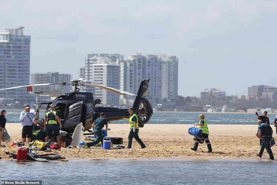Photos show emergency workers rush to help those on board the two Sea World helicopters