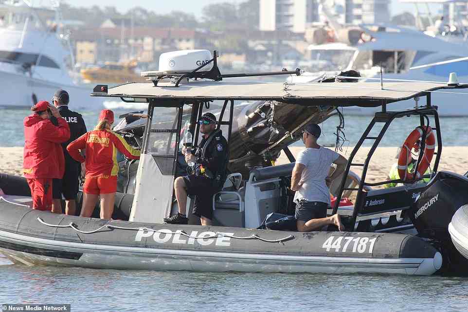 Pictured: Lifeguards and police officers on board one of several vessels that raced to the scene