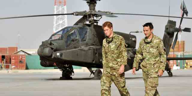 Der britische Prinz Harry wird am 7. September 2012 von einem nicht identifizierten Mitglied seines Geschwaders in Camp Bastion, Afghanistan, die Fluglinie des Apache-Hubschraubers gezeigt.  